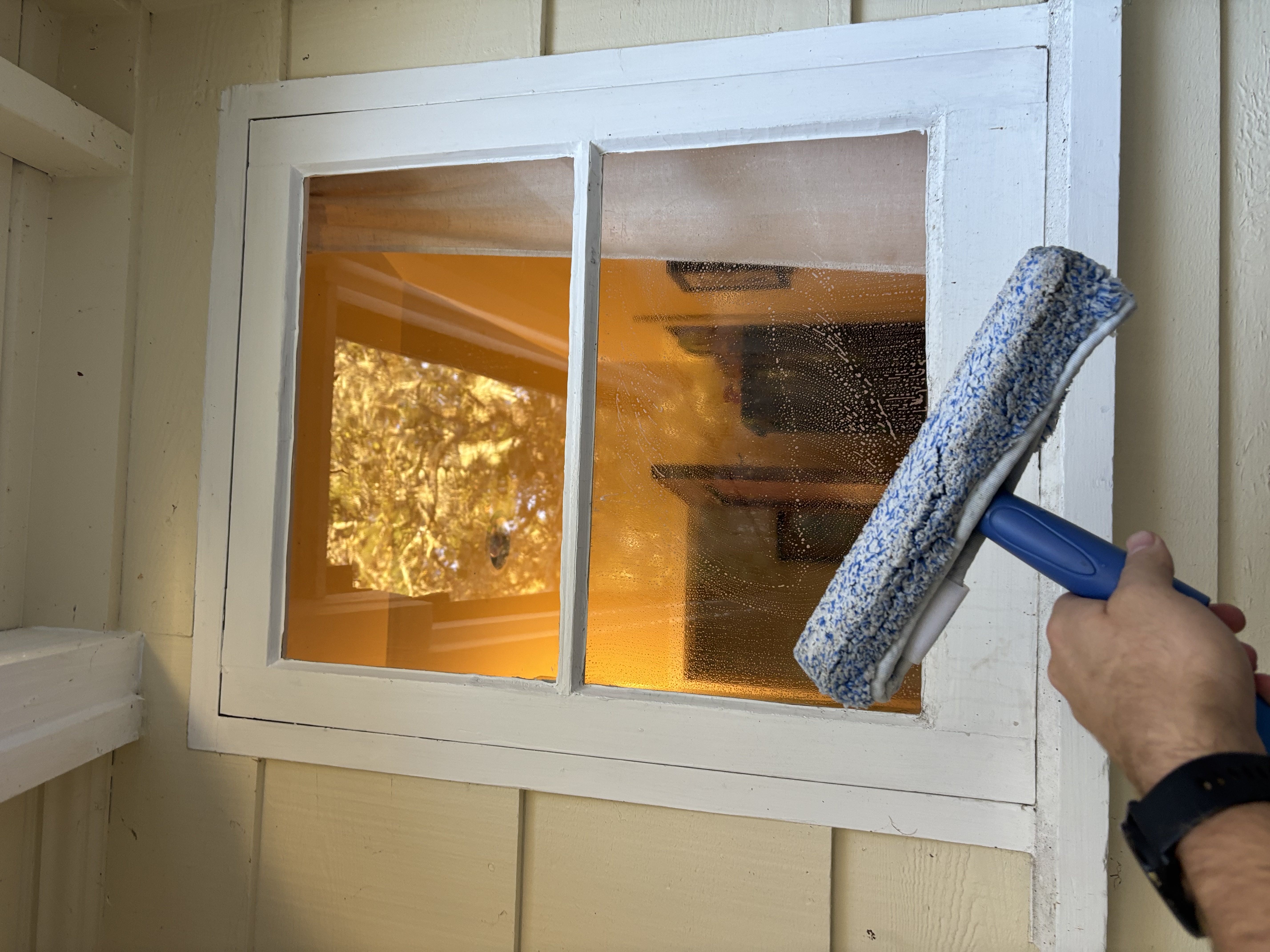 Detail work on window with squeegee