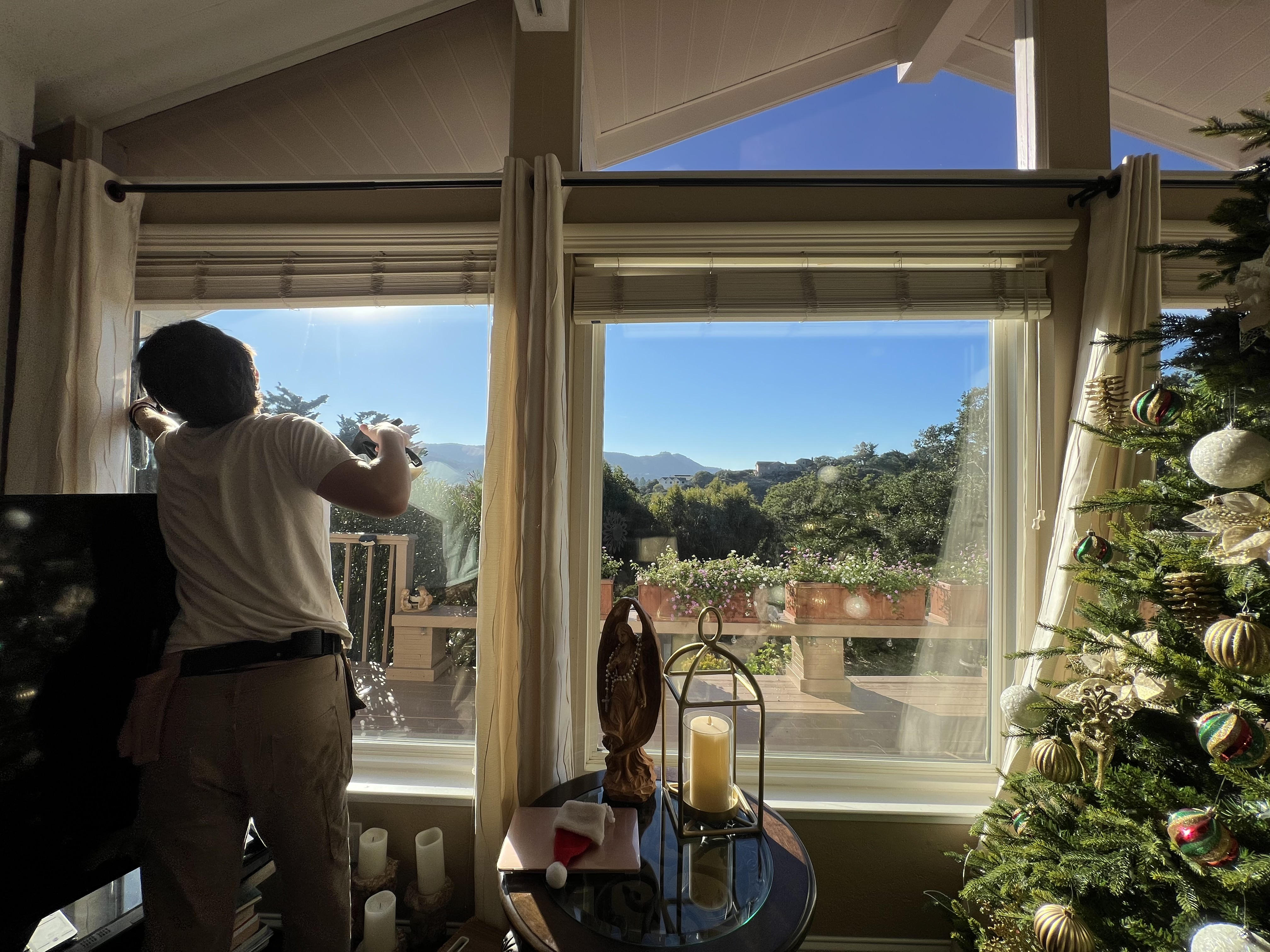 Professional window cleaning service in action with stunning Monterey Peninsula mountain views